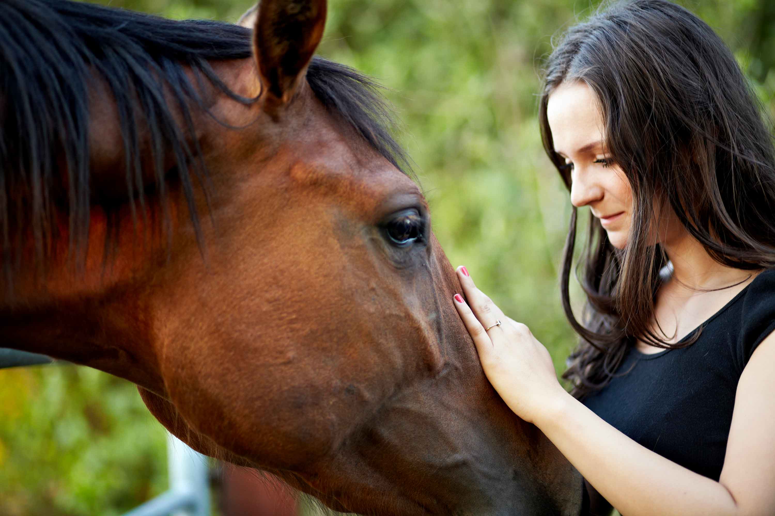 Woman stroking horse whilst on wellness retreat in Marlow near London