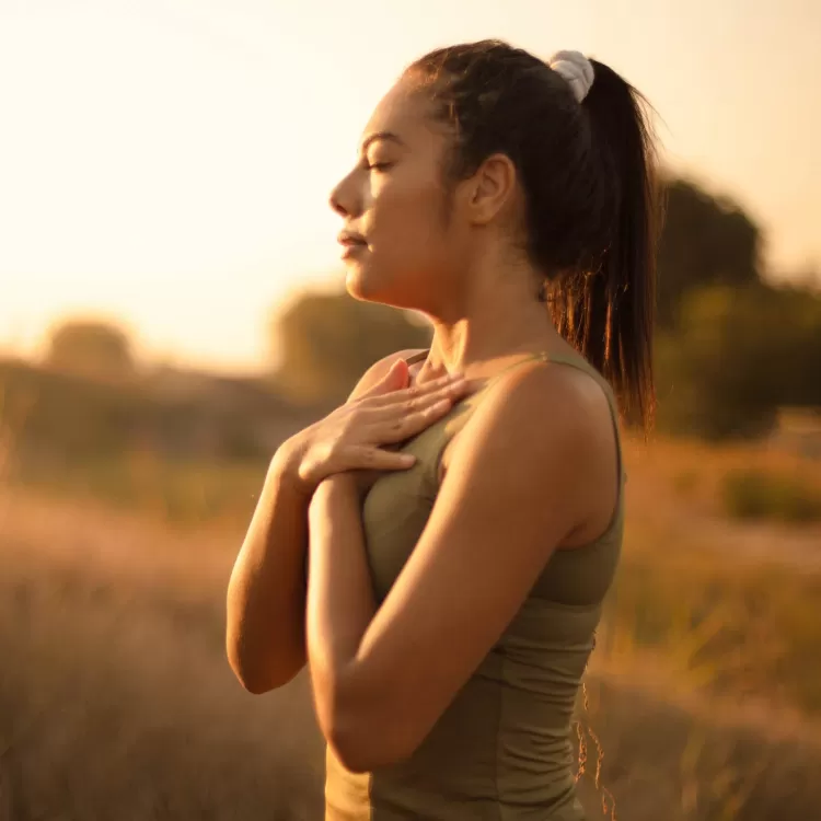 Woman meditating in field